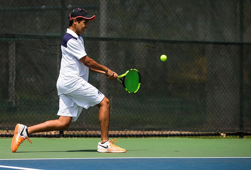 Boys Tennis player hitting the tennis ball